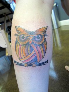 an owl with a ribbon on its leg