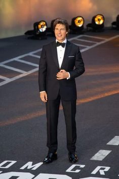 a man in a tuxedo standing on the runway