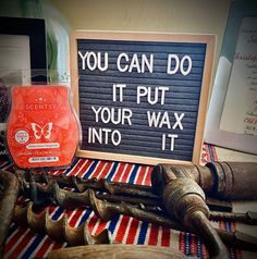 a sign that says you can do it put your wax into it next to some tools