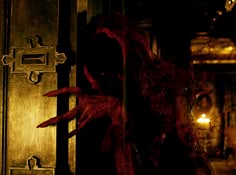 a creepy doll with red hair standing in front of a door