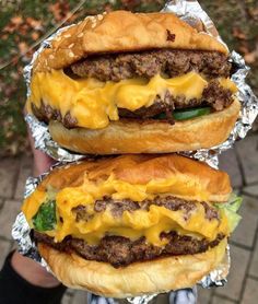 two cheeseburger sandwiches sitting on top of each other