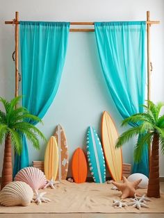 there are surfboards and palm trees in front of the curtains on the beach wall