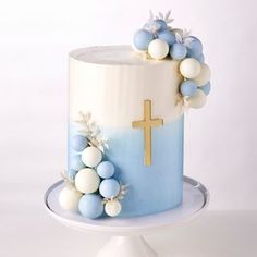 a blue and white cake with a cross on top