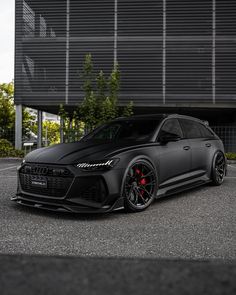 a black car parked in front of a building