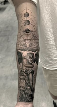 a man with a tattoo on his arm and an angel holding a machine in front of him