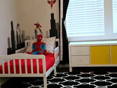 a child's bedroom decorated in spiderman theme