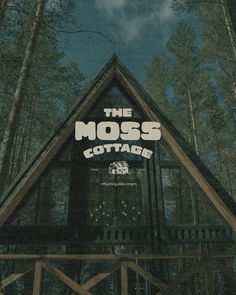 the moss cottage logo is displayed on top of a cabin in the middle of trees