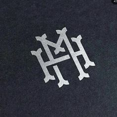 the letter h is made out of silver foil on a black surface with white lettering