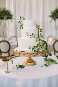 a white wedding cake sitting on top of a table