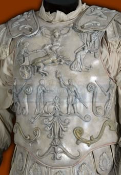 an old white leather armor with elaborate designs on it's chest and shoulder,