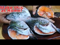 some fish are sitting on a plate and someone is holding one