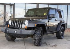 a black jeep parked in front of a building