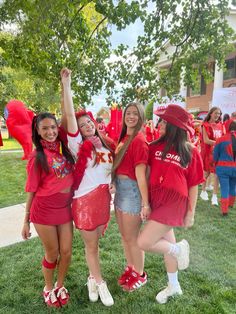 three girls in red and white cheer for the team