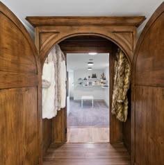 an open wooden door leading to a kitchen