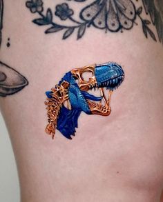 a close up of a person's stomach with tattoos on it and a blue lizard