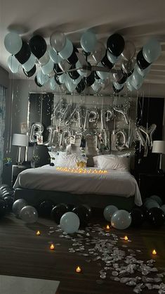 a bedroom decorated with balloons and streamers