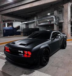 a black sports car parked in a parking garage
