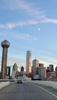 the city skyline is seen from across the highway