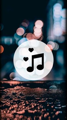 an image of a music note with hearts in the middle and blurry lights behind it