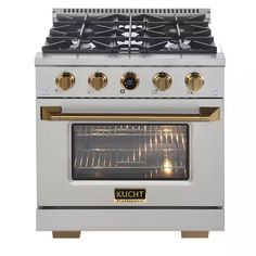 a white stove top oven with two burners on each side and gold trimmings