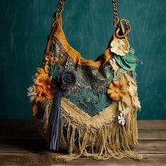 an old purse with flowers and tassels on the handle is sitting on a wooden table