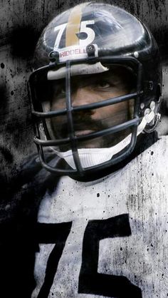 a close up of a football player wearing a helmet with the number 75 on it