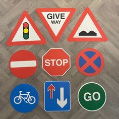 various road signs and traffic lights on the floor