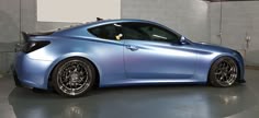 a blue sports car parked in a garage