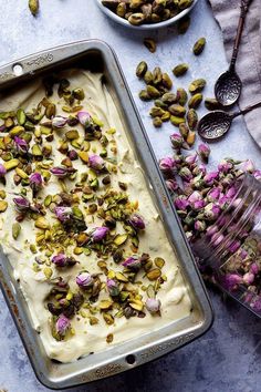 an ice cream dish with pistachios on top and other ingredients around it