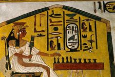 an egyptian painting on the side of a building