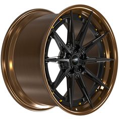 an image of a wheel that is shiny gold and has black spokes on it