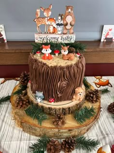 a woodland themed baby shower cake on a table