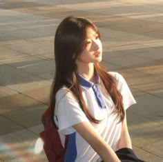 a young woman sitting on top of a skateboard