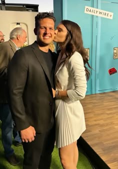 a man and woman standing next to each other