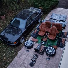 the car is parked on the side of the road next to other items that have been placed around it