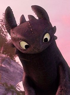 the toothless dragon is standing in front of some rocks and trees with its eyes wide open