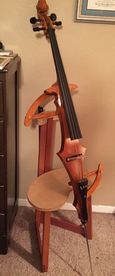 a violin sitting on top of a wooden stand
