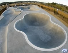 an aerial view of a skateboard park with ramps