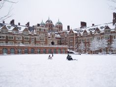 a large building with many windows and snow on the ground