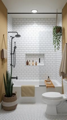 a bathroom with a toilet, tub and plants in it
