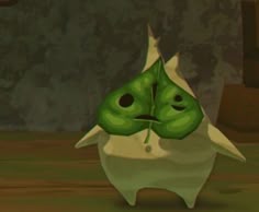 a green creature with two eyes standing in the middle of a room next to a wall