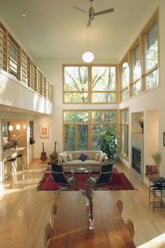 a living room filled with furniture and lots of windows