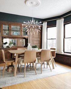 a dining room table with chairs and a chandelier