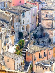 an aerial view of some old buildings with stairs leading up to the roof tops and windows