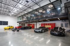 there are many cars in the garage with no one around them or on the floor
