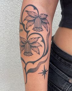 a woman's arm with a flower tattoo on the left side of her body