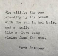 an old typewriter with the words she will be the one standing by the ocean with the sun in her hair and a smile like a love song rising from the sea