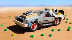 a car made out of legos in the desert