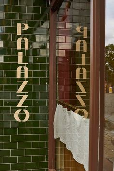 there is a sign in the window that says papa's pizza on it,