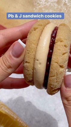 a person is holding a peanut butter and jelly sandwich in their left hand, with the text pb & j sandwich cookies